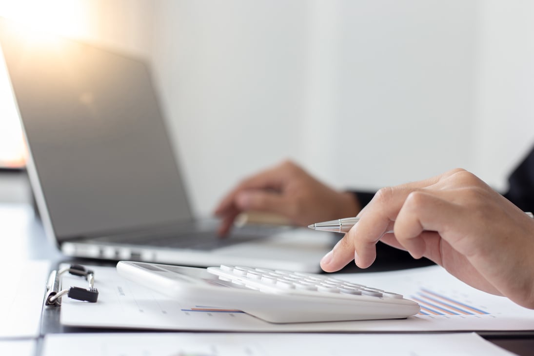 Accountant Typing on a Laptop and Calculator 